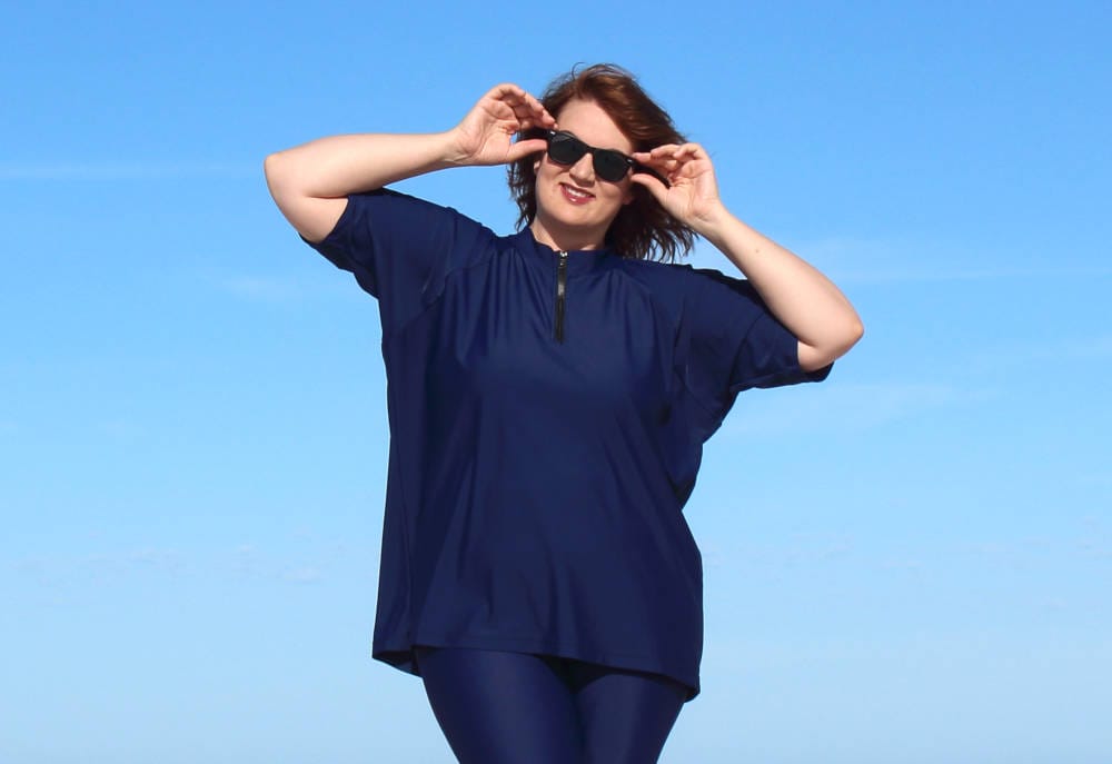 womens wearing baggy rashie on western australia beach banner