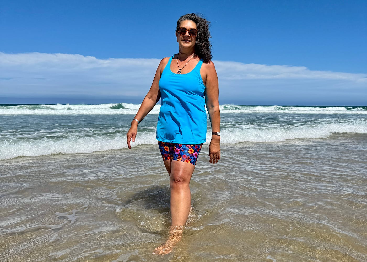 A photo of a woman actually in the water, or walking confidently in the waves.